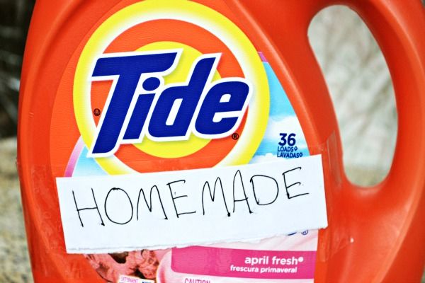 a bottle of tide deterant sitting on top of a pile of carpeting material