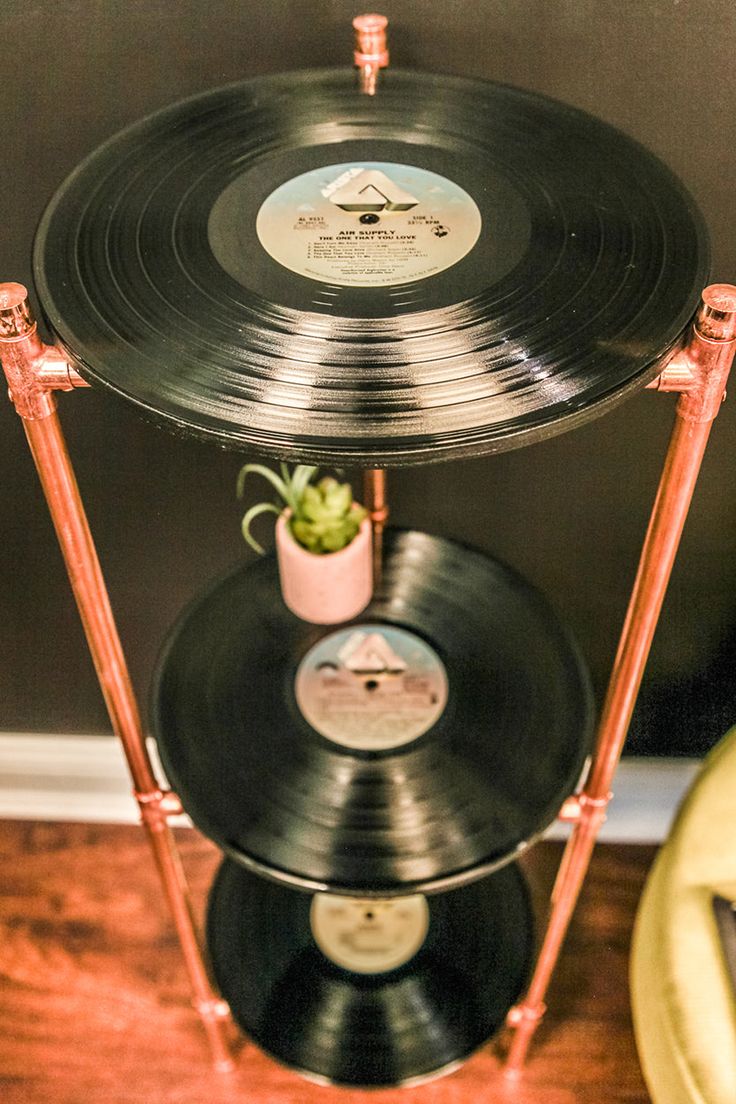 an old record player has a plant in it