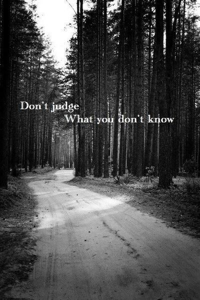 a dirt road surrounded by trees with the words don't judge what you don't know