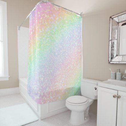 a bathroom with a shower curtain that has pastel colors on it, and a white toilet in the corner