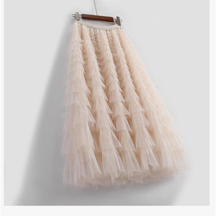 Must Have Skirt For All The Fashion Romantics Out There. An Ivory Ruffle Pleated Tulle Skirt In A Midi Length That Is Easy To Dress Up Or Dress Down. Cream Ruffled Flowy Bottoms, Cream Pleated Tiered Skirt, Spring Tiered Tulle Skirt, Beige Tiered Ruffle Skirt, Beige Ruffled Full Skirt, Spring Tulle Maxi Skirt With Ruffles, Elegant Cream Skirt With Ruffles, Spring Beige Ruffled Maxi Skirt, Beige Ruffled Maxi Skirt For Spring