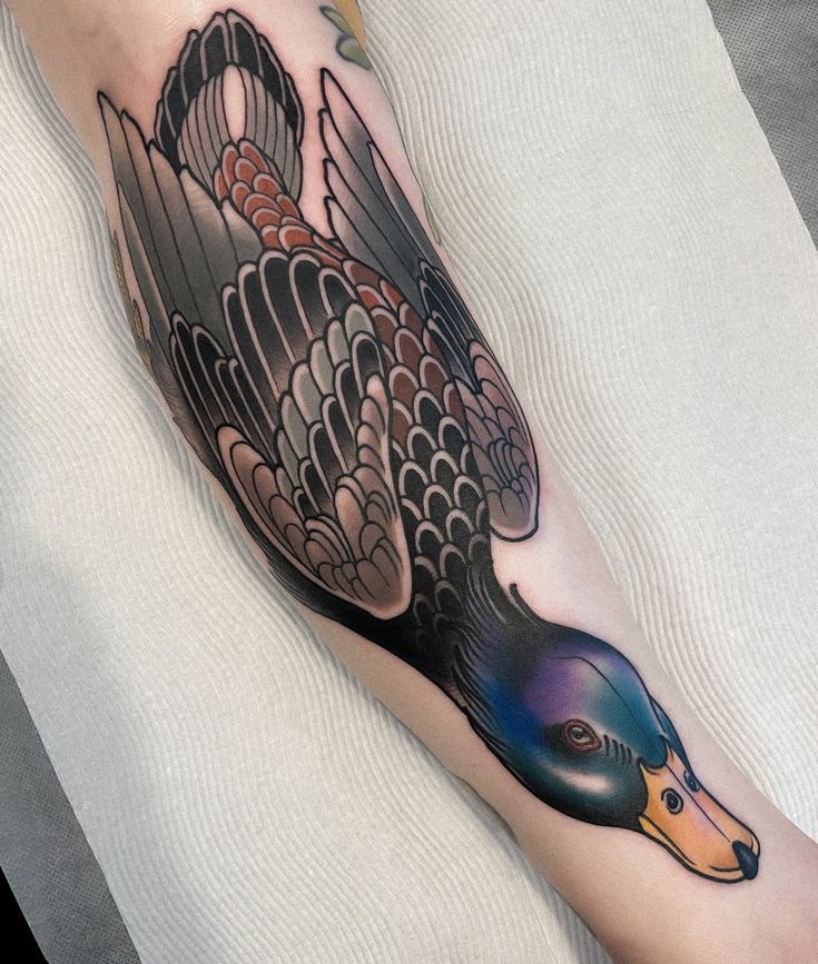 a person with a tattoo on their leg that has a bird on it