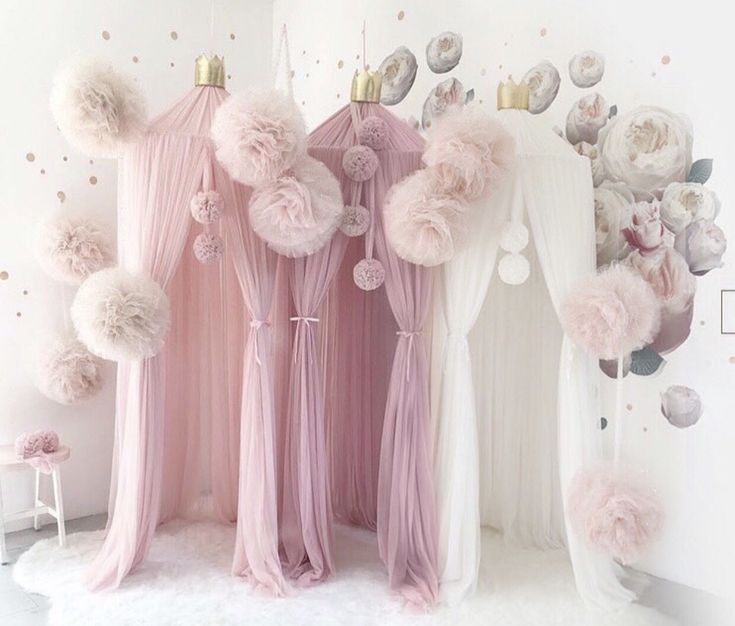 pink and white room with pom - poms on the ceiling, sheer curtained curtains