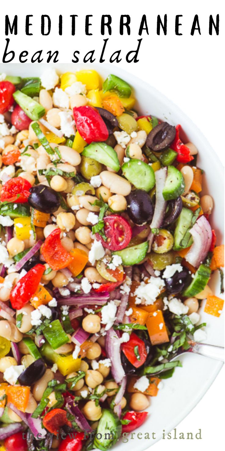 a salad with beans, tomatoes, cucumbers and feta cheese on top