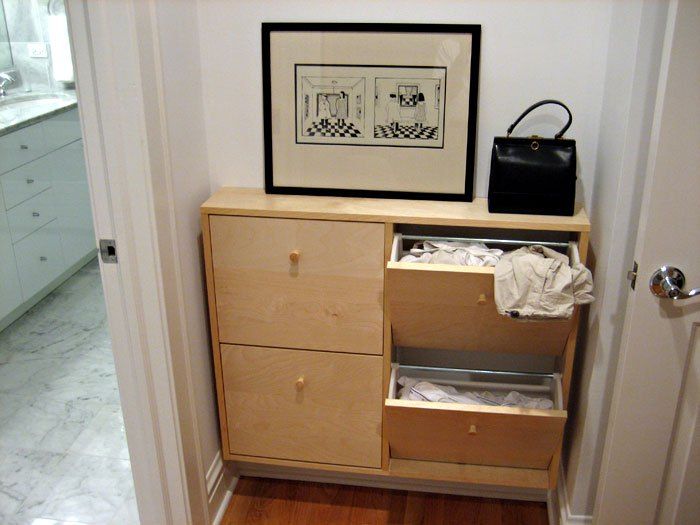 an open cabinet in the corner of a room with a purse on top of it