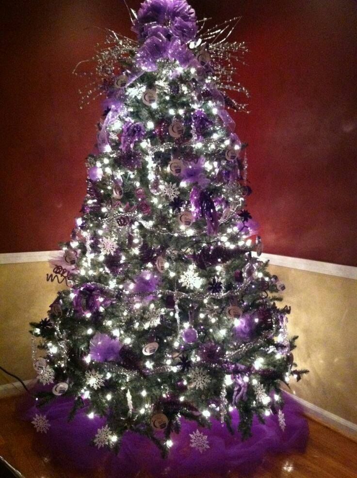 a decorated christmas tree with purple and silver decorations