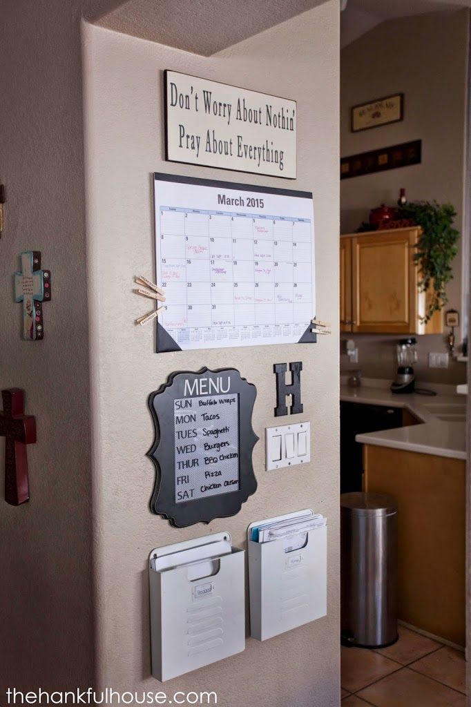 a refrigerator with magnets on it and a calendar attached to the side of it