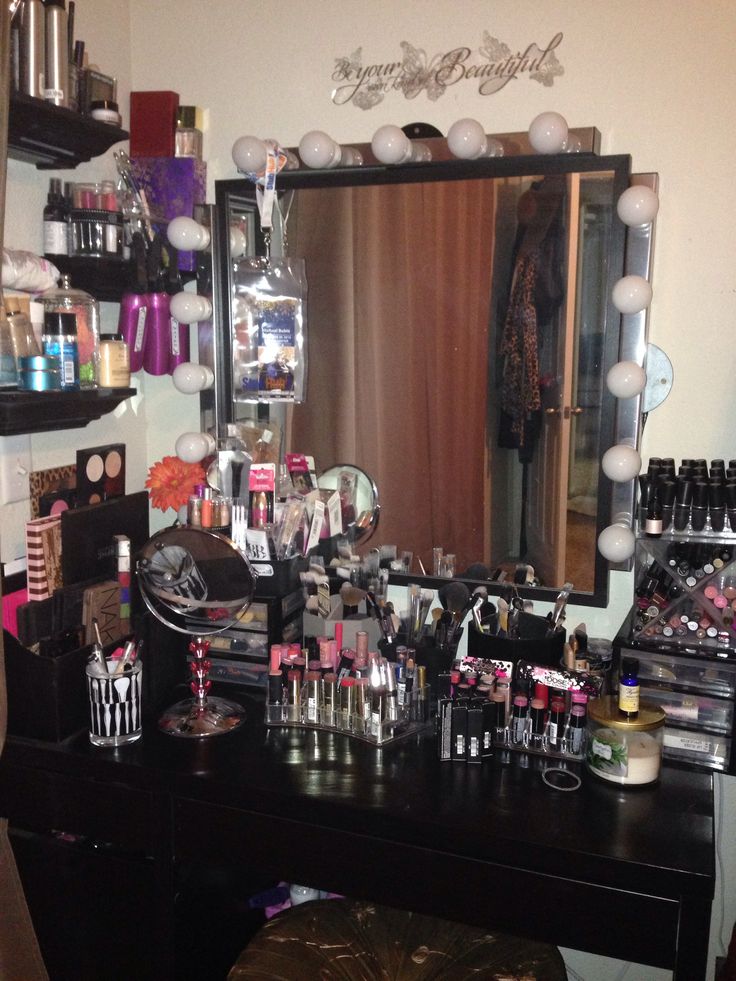 a vanity with lots of makeup and other items on it