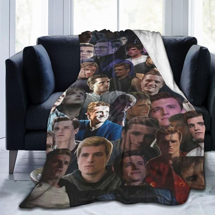 a blanket with many photos of people on it in front of a couch and window