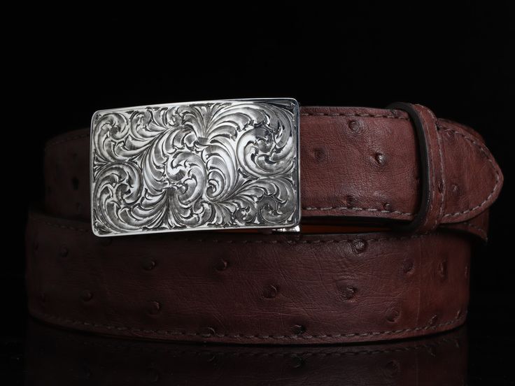 One of our most popular buckles, this understated piece by Comstock Heritage is perfect for those just starting their buckle collections, or for more formal occasions. It’s made from heavy-gauge, hand-engraved Sterling silver, and its rectangular face is adorned with beautiful, delicate scrollwork. This buckle can be paired easily blue jeans or be worn with dressier slacks. This buckle comes in two sizes as well. First smaller size measures approx. 1 5/8" x 2 5/8" and fits all 1.25" belt traps S Luxury Formal Belts With Silver Buckle, Luxury Formal Belt With Silver Buckle, Designer Formal Belt Buckle Rectangular, Luxury Formal Jewelry With Silver Buckle, Classic Silver Belt With Palladium Hardware, Classic Formal Belt With Silver Buckle, Western Engraved Belt Buckles For Formal Wear, Vintage Engraved Belt Buckles For Formal Wear, Vintage Engraved Belt Buckles For Formal Occasions