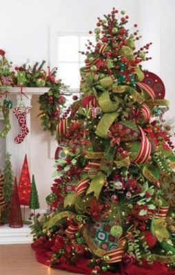 two christmas trees decorated with green and red ribbons