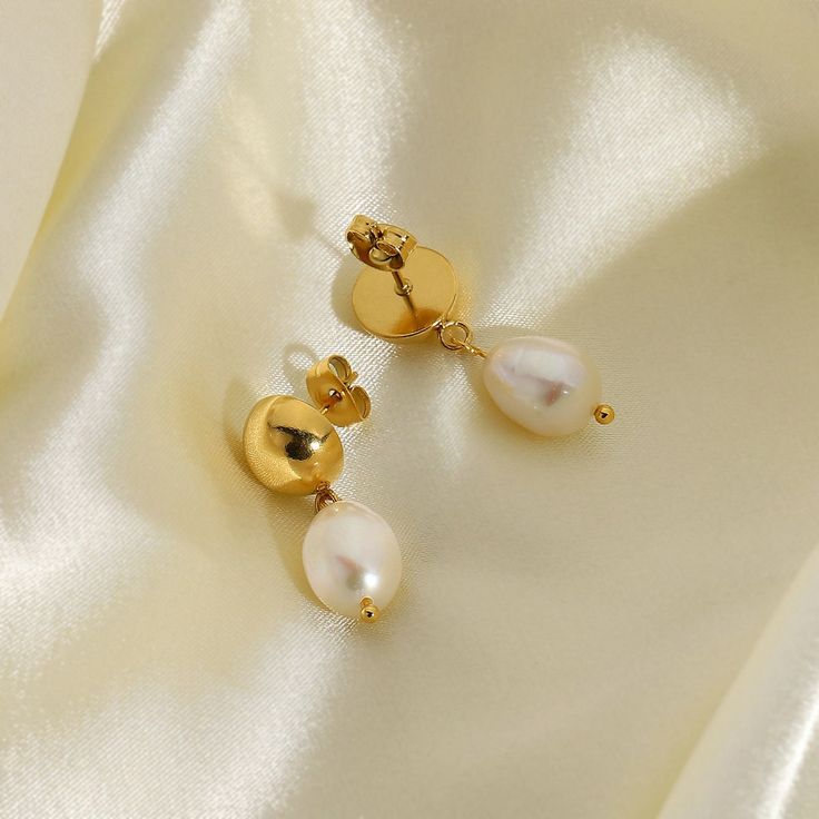 Indulge in the classic beauty of Pearl Drop Earrings, elegantly crafted in 18k gold plating. These earrings feature lustrous pearls that gracefully dangle, adding a touch of timeless sophistication to any attire. Classic Pear-shaped Gold Earrings, Elegant Pear-shaped Pearl Chain Earrings, Timeless Gold Pearl Earrings For Wedding, Classic Drop Earrings With Pearl Chain, Gold Pearl Earrings For Wedding, Gold Pearl Drop Dangle Earrings, Elegant Formal 14k Gold Filled Pearl Earrings, Gold Dangle Earrings With Pearl Drop, Gold Plated Gold Pearl Dangle Earrings