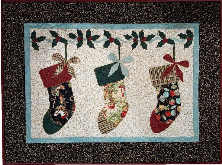 quilted christmas stockings hanging on a wall