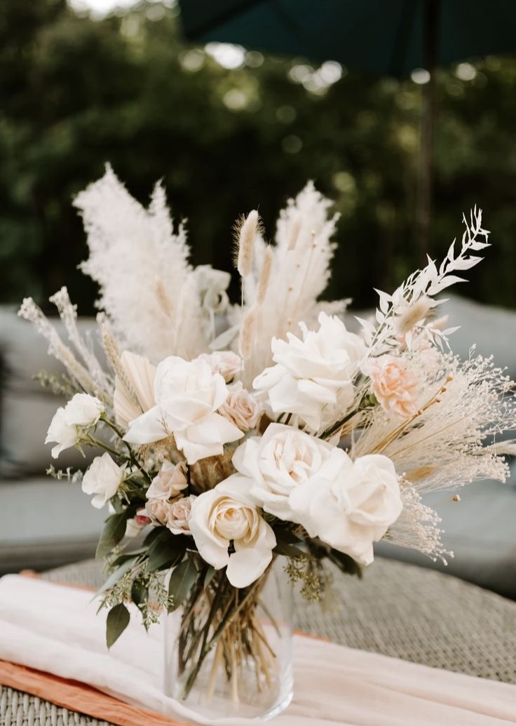 a vase filled with white flowers on top of a table