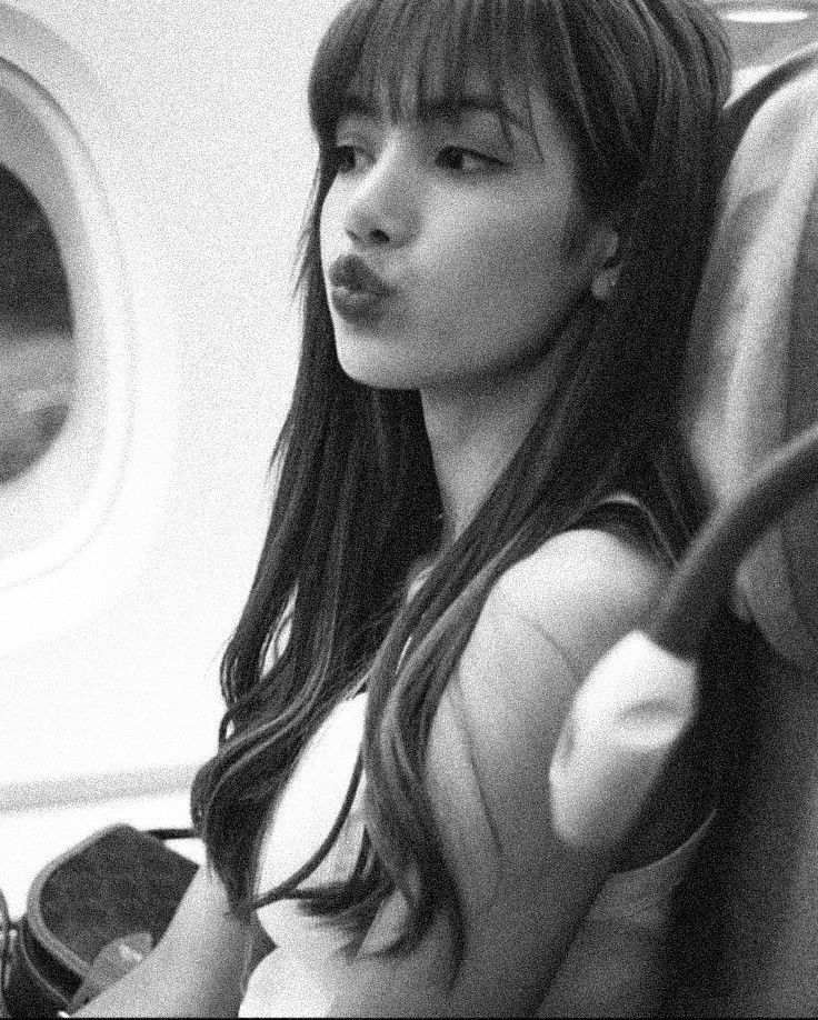 a woman sitting on an airplane looking out the window