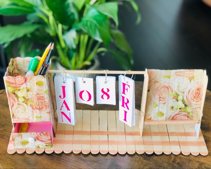 a small desk with flowers and notepads on it that spell out the word march