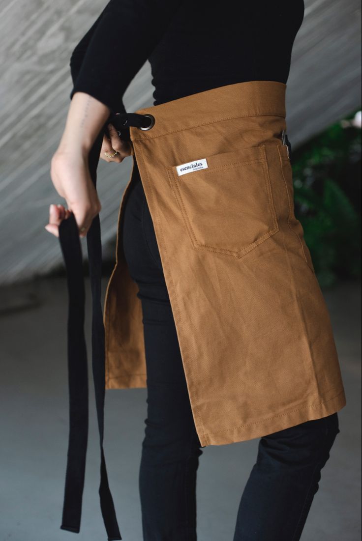 a woman wearing an apron and holding a black belt