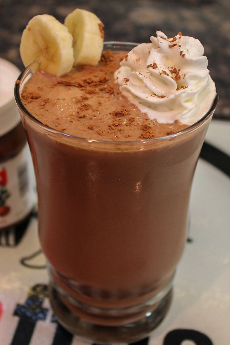 a chocolate drink with whipped cream and bananas on top