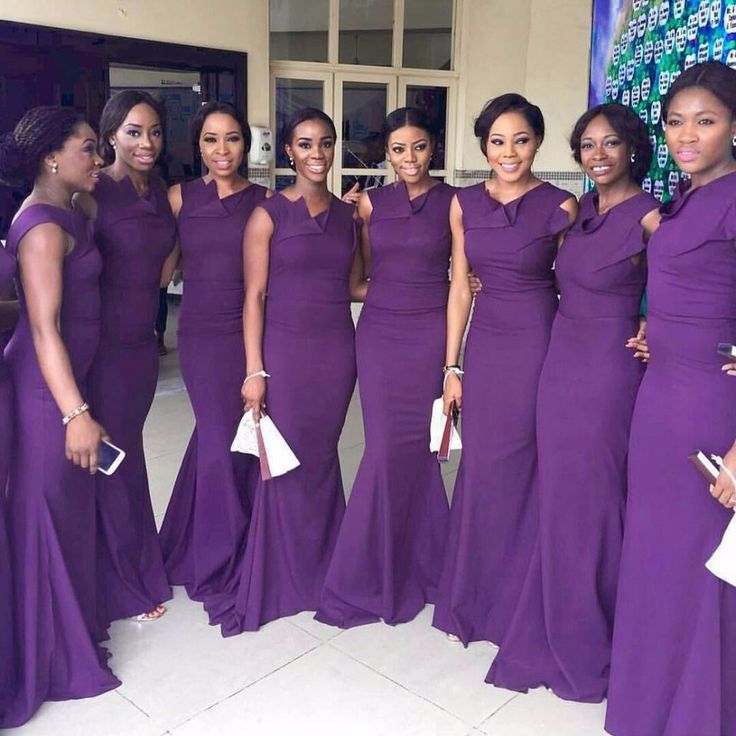 a group of women standing next to each other in purple dresses