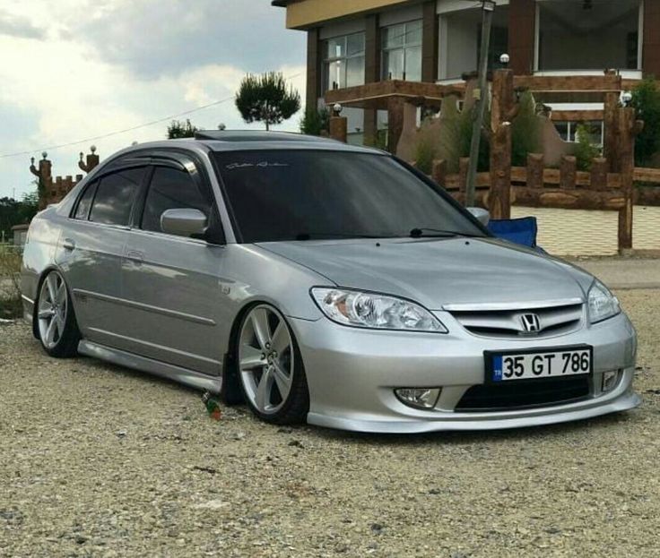 a silver car parked in front of a house