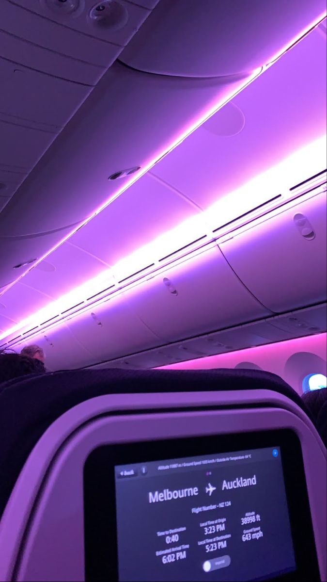 the interior of an airplane with purple lighting