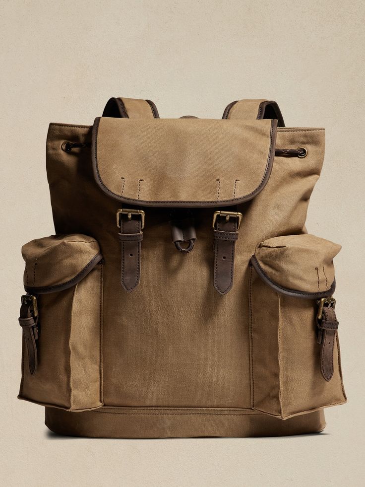 Expertly crafted for rugged adventure, this sturdy heritage backpack is a reimagined version of an archived classic with secure storage and extra pocket space for findings along the way.  Flap closure with buckles and drawstring.  Spacious side pocke Rugged Backpack With Adjustable Strap, Utility Backpack With Pockets For Outdoor, Outdoor Flap Backpack With Pockets, Rugged Adventure Bag With Pockets, Utility Backpack With Multiple Pockets, Utility Travel Backpack, Utility Backpack For Outdoor Activities, Classic Backpack For Outdoor Activities, Backpack Vintage