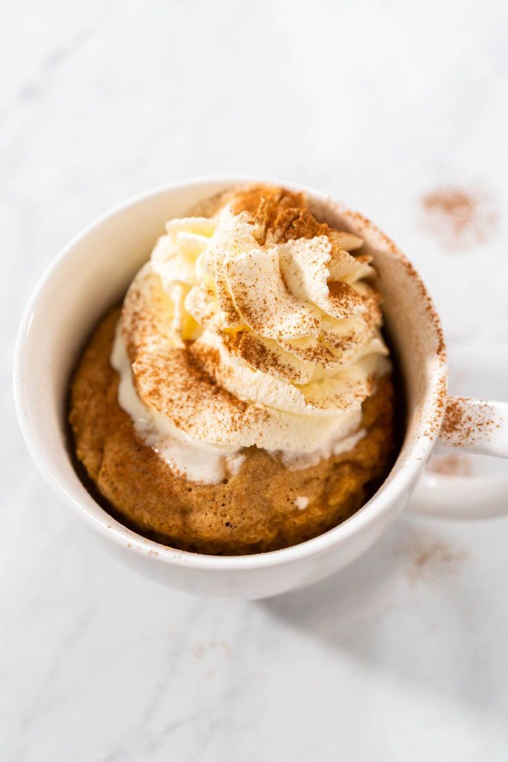 a cup filled with cinnamon and whipped cream