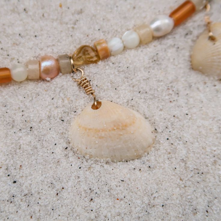 This necklace features hand-picked cockle shells from Anna Maria Island beaches and a mix of pearls and stones, for the girls that want to feel like sunshine all the time. ABOUT THE NAME A best-kept secret among Florida-frequenters, Anna Maria Island is a place where old coastal charm is still the norm, flip flops are a way of life and the speed limit never exceeds 35mph. MATERIALS Anna Maria Island cockle shells, white and blush freshwater pearls, pink coral, citrine, and howlite stones on a 15 Adjustable Shell Necklace With Pearl Charm, Pearl Shell-shaped Necklace For Beach, Spiritual Beaded Shell Necklace For Beach, Pearl Shell Necklace For The Beach, Ocean-inspired Shell Necklace With Pearl Charm For Beach, Beach Shell Necklace With Pearl Charm, Shell-shaped Necklace With Pearl Charm For Beach, Shell Necklace With Pearl Charm For Beach, Ocean-inspired Shell With Pearl Charm For Beach