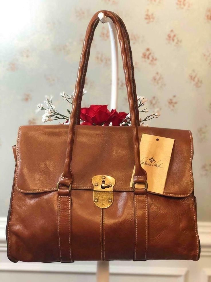 NWT PATRICIA NASH "Vienna" Tan Brown Leather Satchel Bag $249 #P53101 NWT PATRICIA NASH "Vienna" Tan Brown Leather Satchel Bag $249 #P53101 Description NWT PATRICIA NASH "Vienna" Tan Brown Leather Shoulder Satchel Bag Style #P53101  Front flap turnlock closure Bronze tone hardware Exterior has one magnetic, two side magnetic pockets Adjustable opening One magnetic large pocket undet the flap Fully interior lining Interior has two slip in and one zip pockets Bottom studs for extra protection Doub Brown Satchel Bag With Leather Patch, Leather Lined Flap Bag, Leather Handles Flap Satchel, Elegant Satchel With Leather Handles And Flap Shape, Elegant Shopping Satchel With Flap, Elegant Flap Satchel For Shopping, Leather Flap Satchel For Shopping, Shopping Satchel With Gold-tone Hardware And Flap, Vintage Brown Flap Satchel