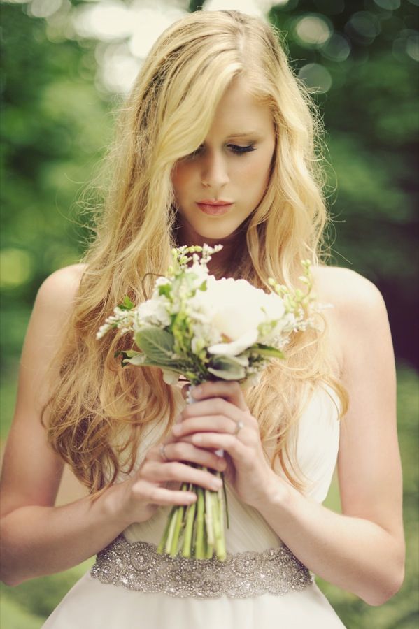 a woman holding a bouquet of flowers in her hands