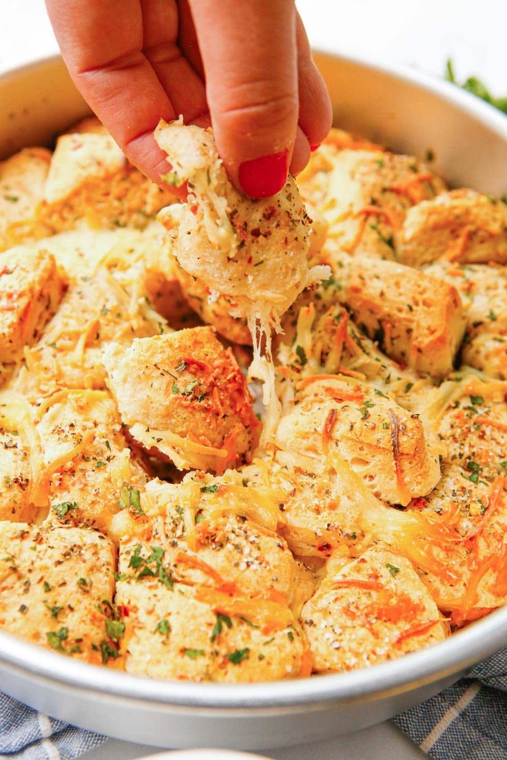 a person is dipping some food into a casserole dish with broccoli and cheese