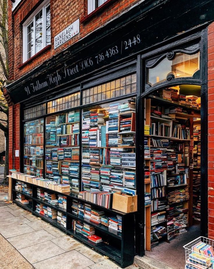 a book store with lots of books on the front and shelves full of books outside