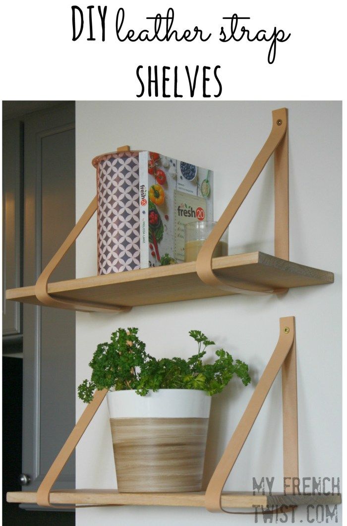 two wooden shelves with plants and books on them, one shelf has a potted plant