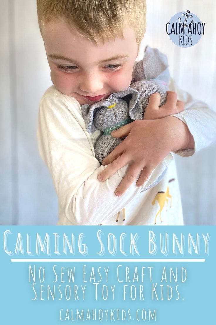 a young boy holding a stuffed animal with the caption saying, calming sock bunny no sew easy craft and sensory toy for kids