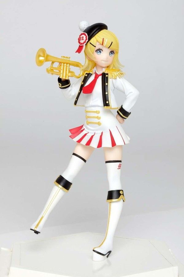 a figurine is holding a trumpet in her hand and posing for the camera