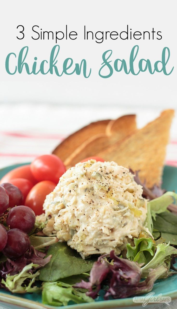 chicken salad on a plate with bread and grapes