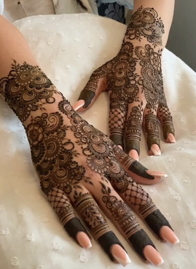 a woman's hands with hennap on top of her arm and hand