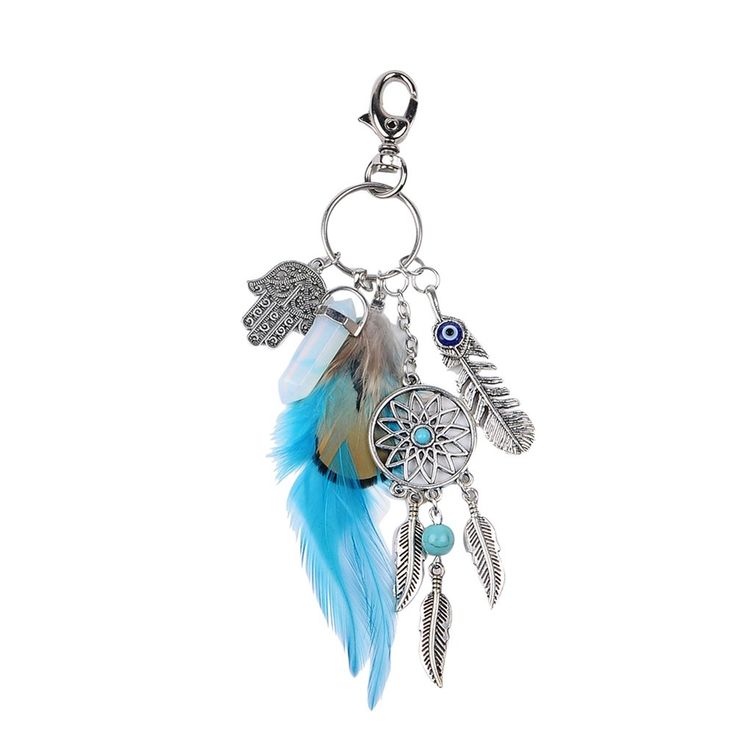 a key chain with feathers and beads on it