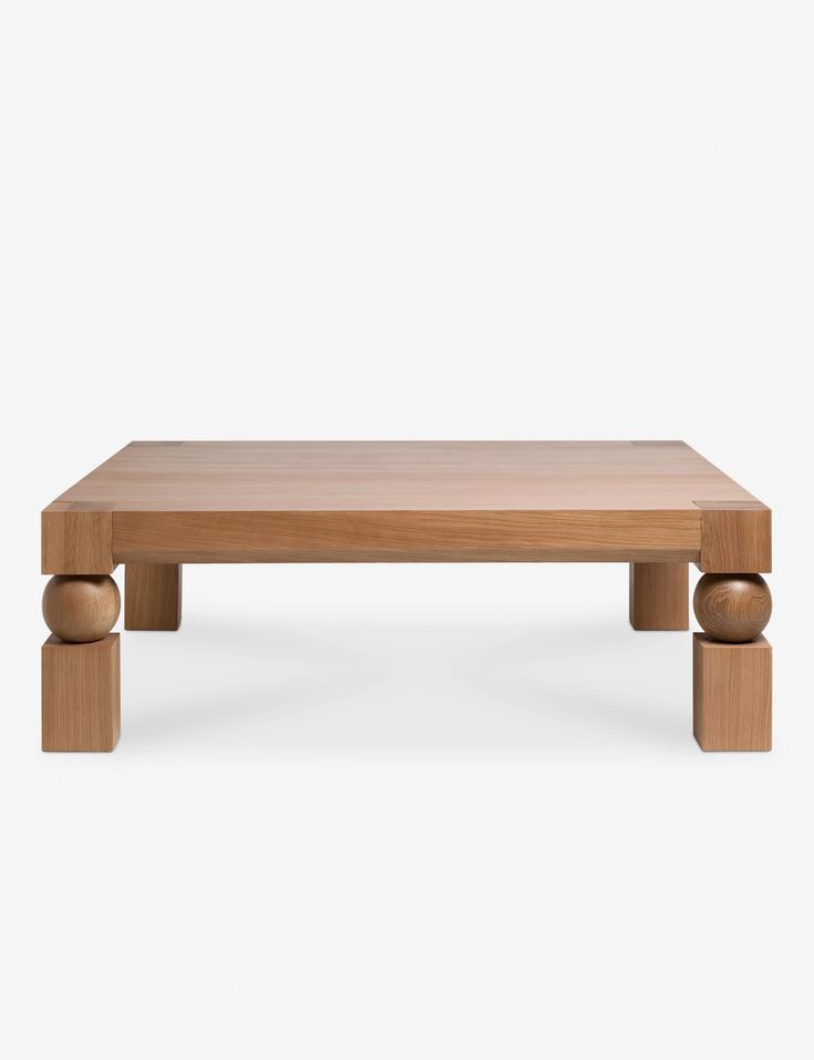 a wooden coffee table with three legs