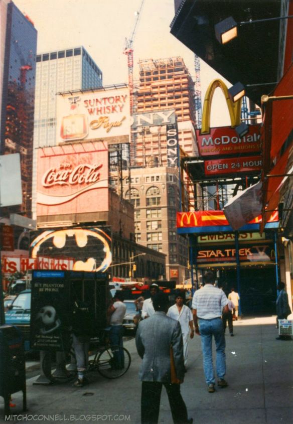 people are walking down the street in new york city