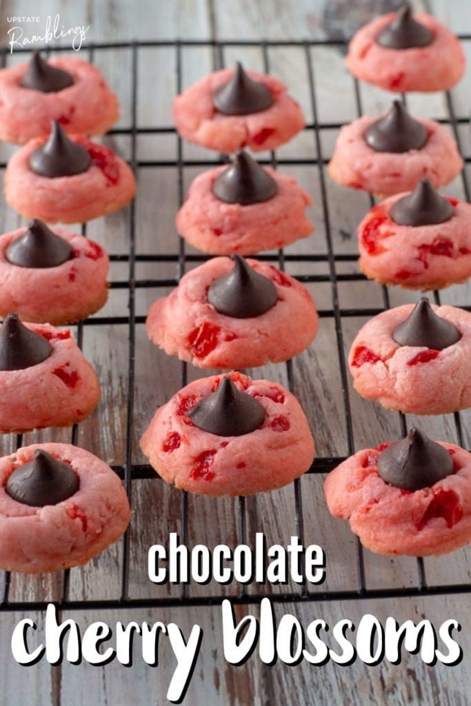 chocolate cherry blossom cookies on a cooling rack with the words chocolate cherry blossoms over them