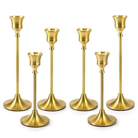 six gold candlesticks are lined up in a row