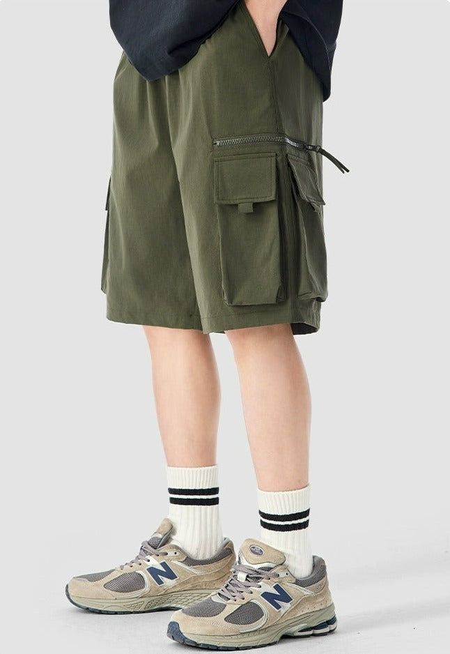 Experience functionality and style with our Cargo Utility Shorts, complete with a zippered pocket for the modern man on the go. Crafted from a breathable blend of 90% nylon and 10% spandex, these shorts feature a low waist, loose straight fit, and ice silk quick-drying properties for ultimate comfort. The edgy design includes a durable dual-duty stitch, ample storage with a large utility pocket, and a classic straight-cut hem for a relaxed silhouette. Versatile and comfortable, these shorts are Utility Bermuda Bottoms With Built-in Shorts, Sporty Bermuda Cargo Shorts With Side Pockets, Sporty Cargo Shorts With Built-in Shorts, Knee-length Shorts With Pockets For Outdoor Activities, Sporty Bermuda Bottoms With Cargo Pockets, Nylon Athleisure Shorts With Cargo Pockets, Sporty Bermuda Cargo Shorts, Nylon Athleisure Cargo Shorts, Functional Nylon Cargo Shorts For Streetwear