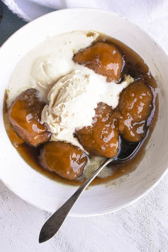 a white bowl filled with ice cream and some kind of dessert on top of it