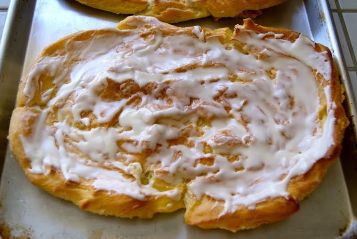 two pastries sitting on top of a pan covered in icing