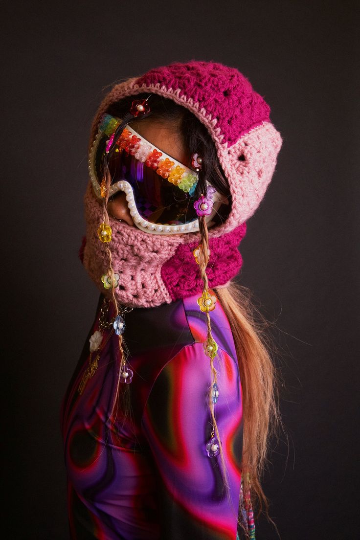 a woman wearing ski goggles and a knitted hat