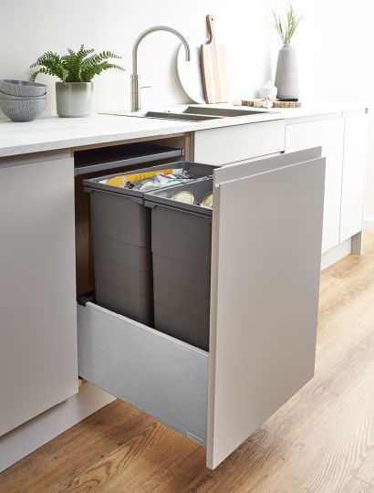 an open cabinet in the middle of a kitchen