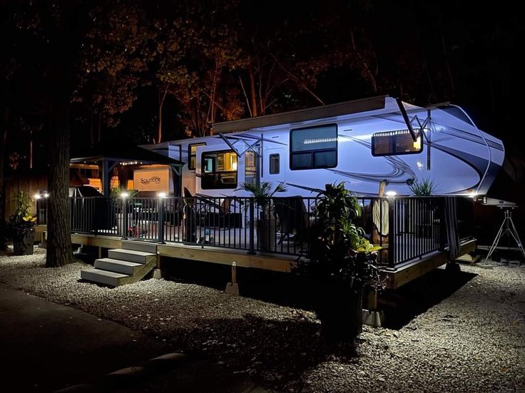 an rv parked on the side of a road at night with its lights turned on