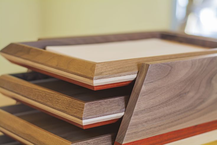 three wooden trays stacked on top of each other