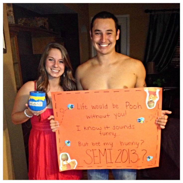 a man and woman standing next to each other holding a sign that says life would be pooh without you